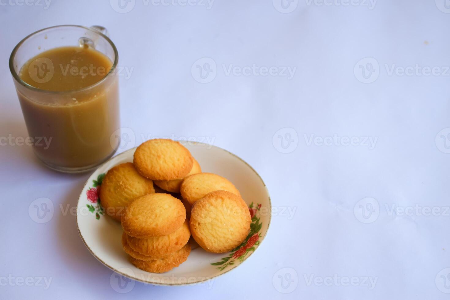 breakfast menu in the form of Danish butter cake and a glass of chocolate milk, Close up of butter cookies coated with white sugar and a glass of chocolate, sweet cake photo