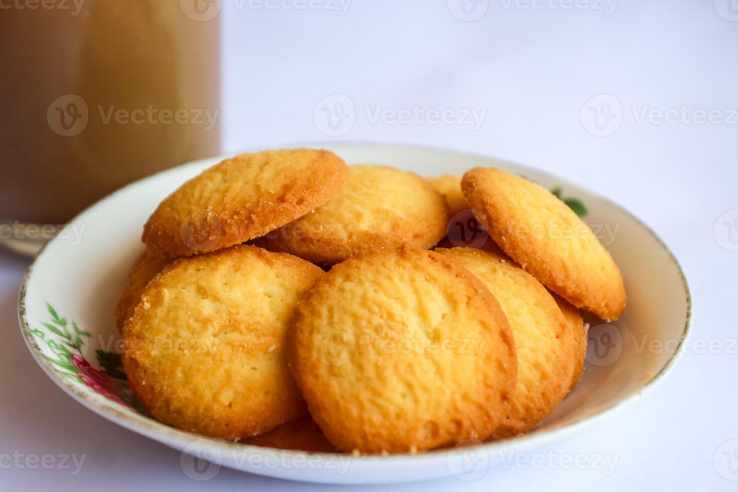 breakfast menu in the form of Danish butter cake and a glass of chocolate milk, Close up of butter cookies coated with white sugar and a glass of chocolate, sweet cake photo