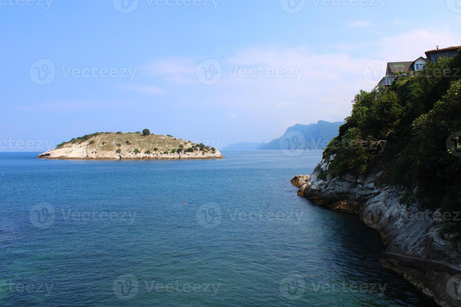 An island in the middle of the sea and the rocks next to it. Amasra, Bartin, Turkey photo