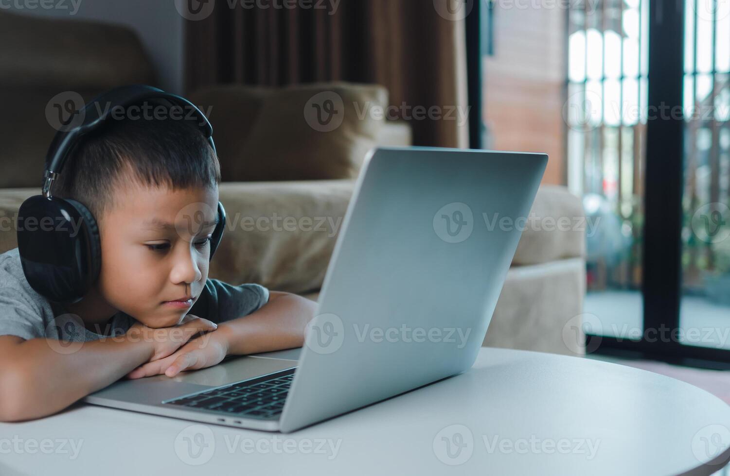 Online education, Technology studying at home using laptop computer, Student distance learning virtual distance online class on call virtual lesson, Teaching child boy with remote education. photo
