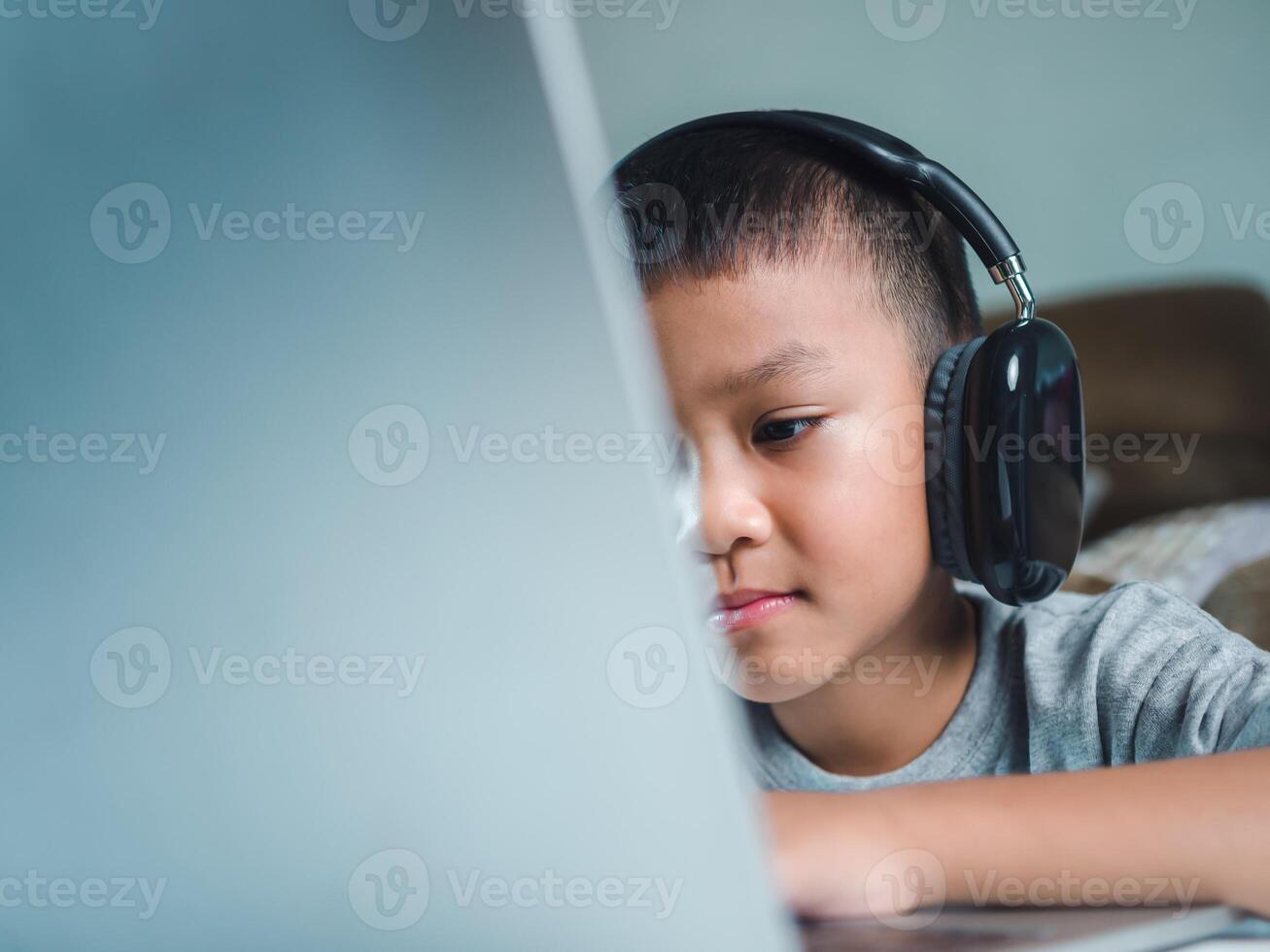 Online education, Technology studying at home using laptop computer, Student distance learning virtual distance online class on call virtual lesson, Teaching child boy with remote education. photo