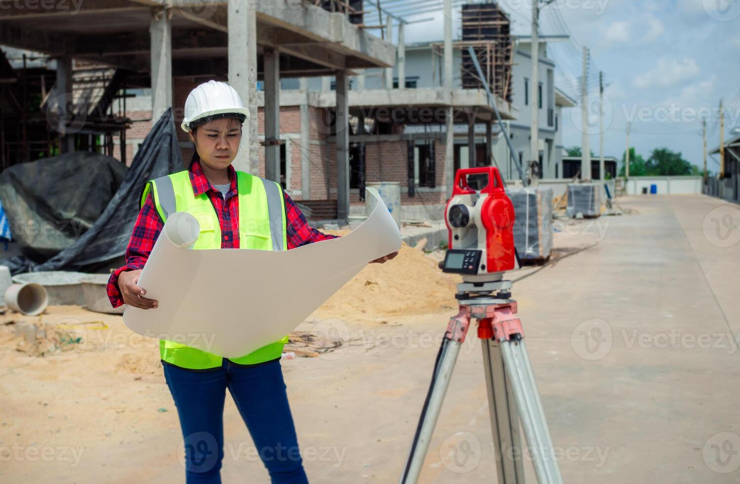 Engineers holding blueprint project working outdoors building side with blueprints on a worksite, Engineering and architecture concept, Engineer working at site of a large building project. photo