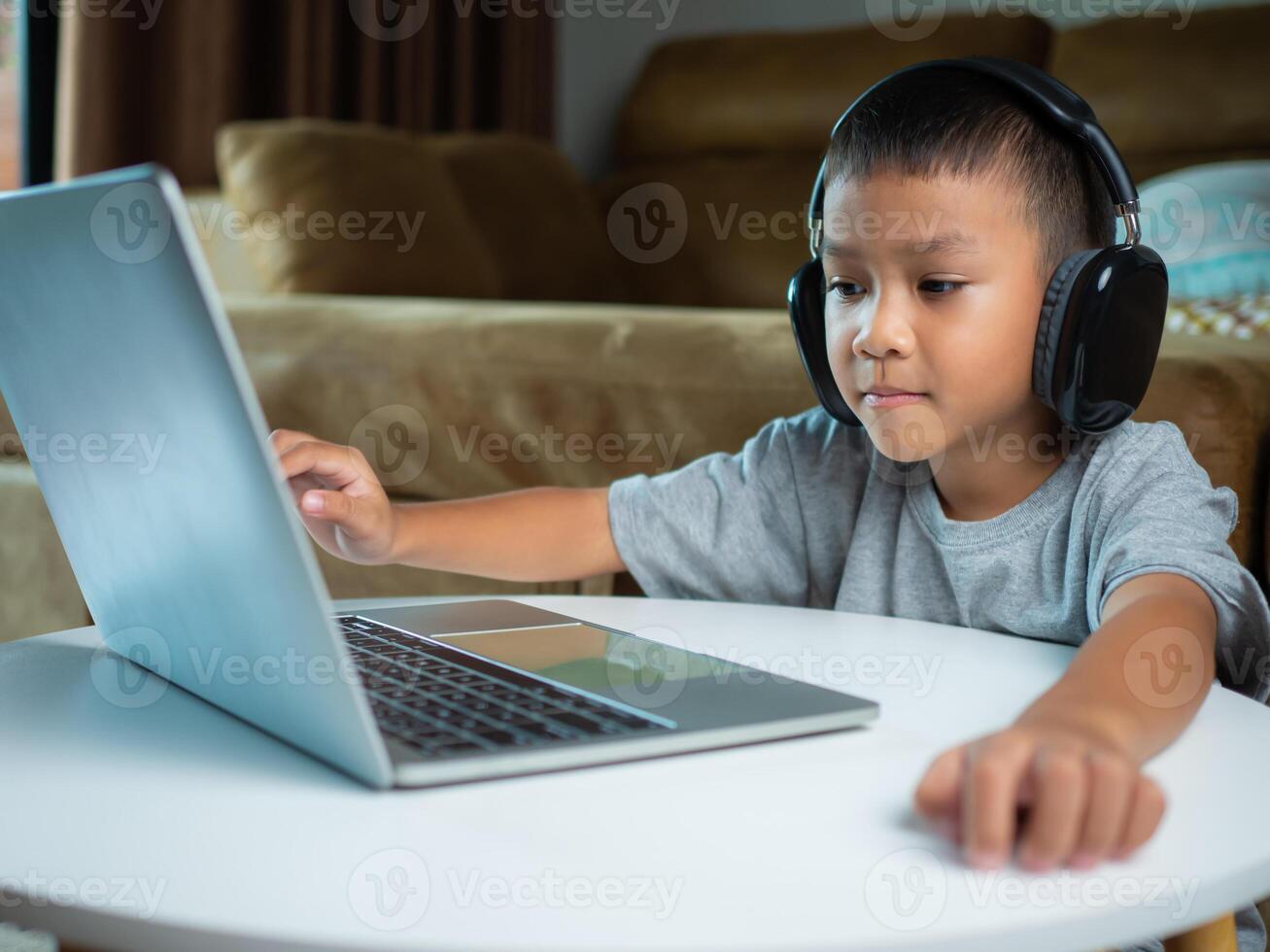 Online education, Technology studying at home using laptop computer, Student distance learning virtual distance online class on call virtual lesson, Teaching child boy with remote education. photo