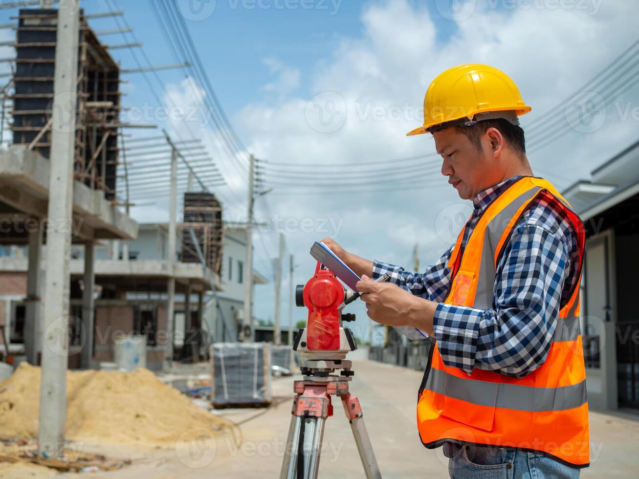 Engineers holding documents for planning and design for project at worksite, Engineering and architecture concept, Engineer working at site of a large building project. photo