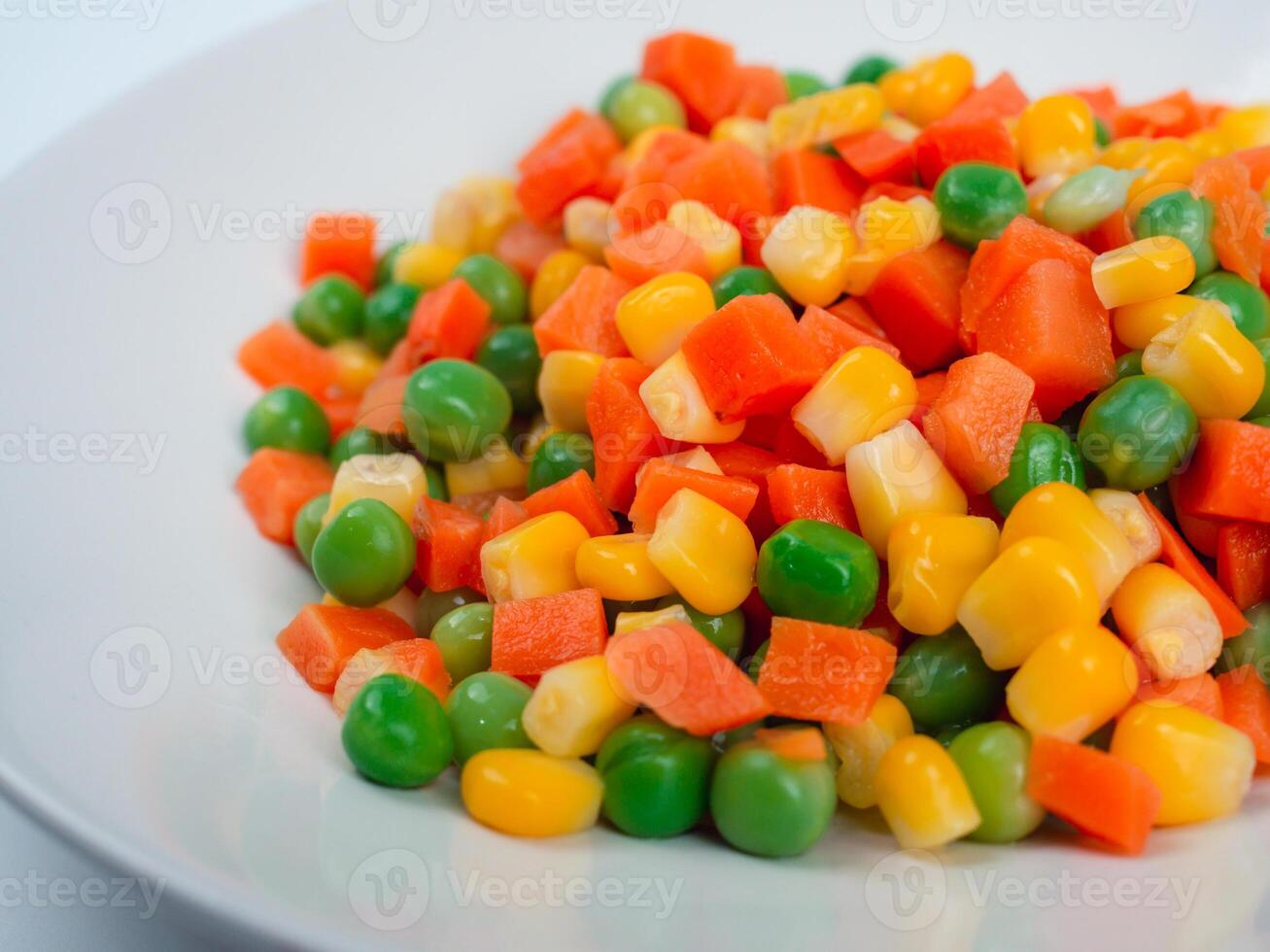 Organic Food. Mixed Vegetables Isolated White Background. Vegetable containing carrots, peas, and corn on white background, Healthy food, Colorful mixed vegetables. photo