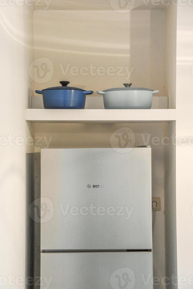 A refrigerator with two pots on top of it photo