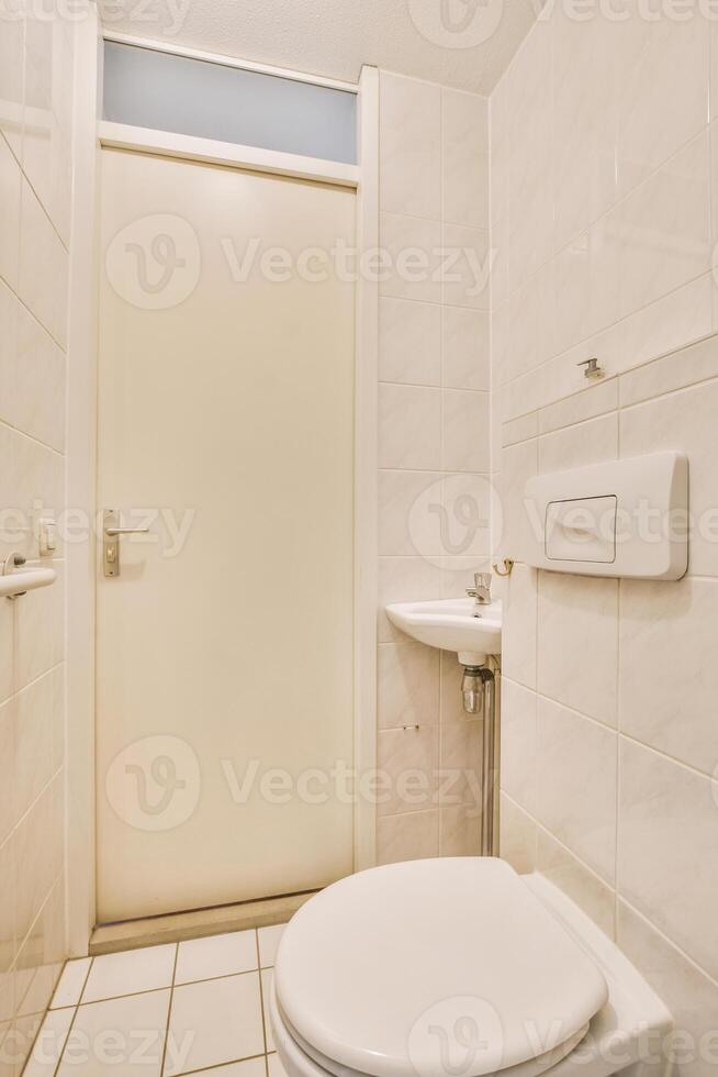 A white toilet in a bathroom photo