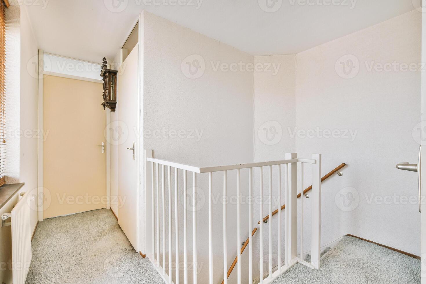 A stairway in a small apartment with a white railing photo