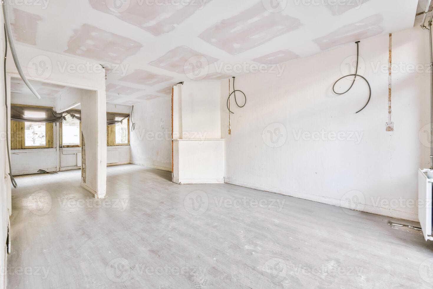 Empty room with white walls and wood floors photo