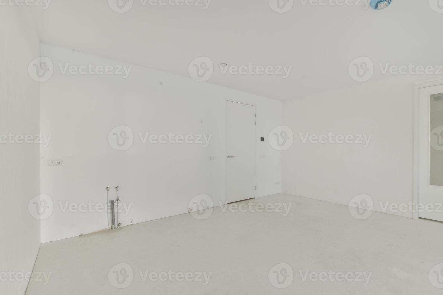 An empty room with white walls and a door photo