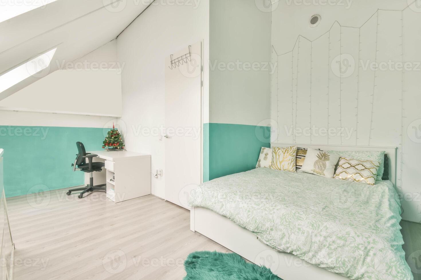 A bedroom with a bed, desk and a window photo