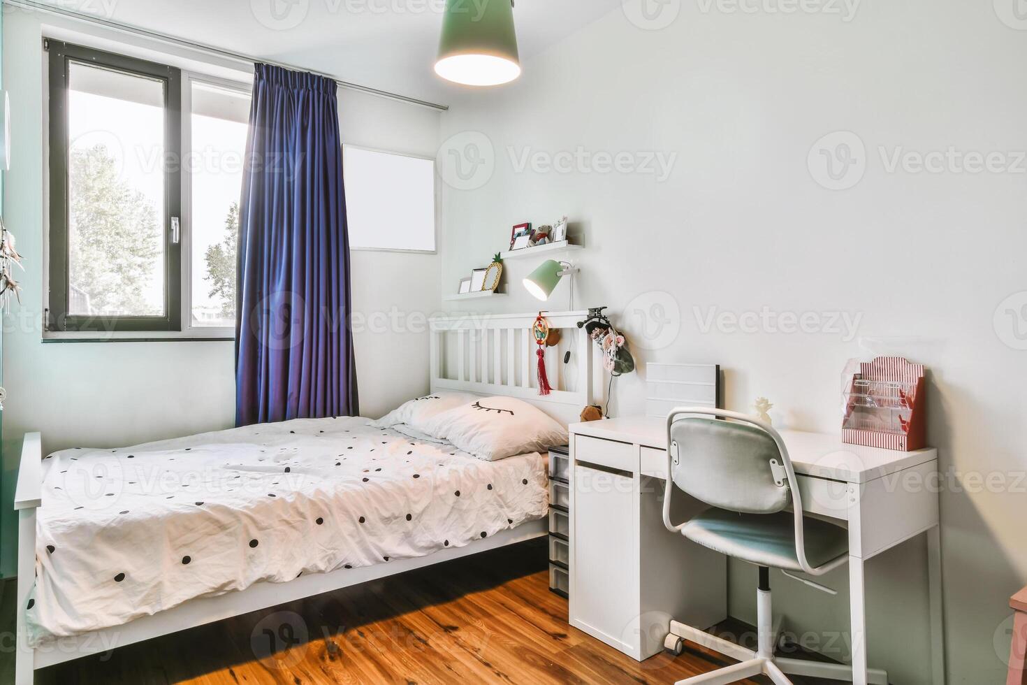 A bedroom with a bed, desk and window photo