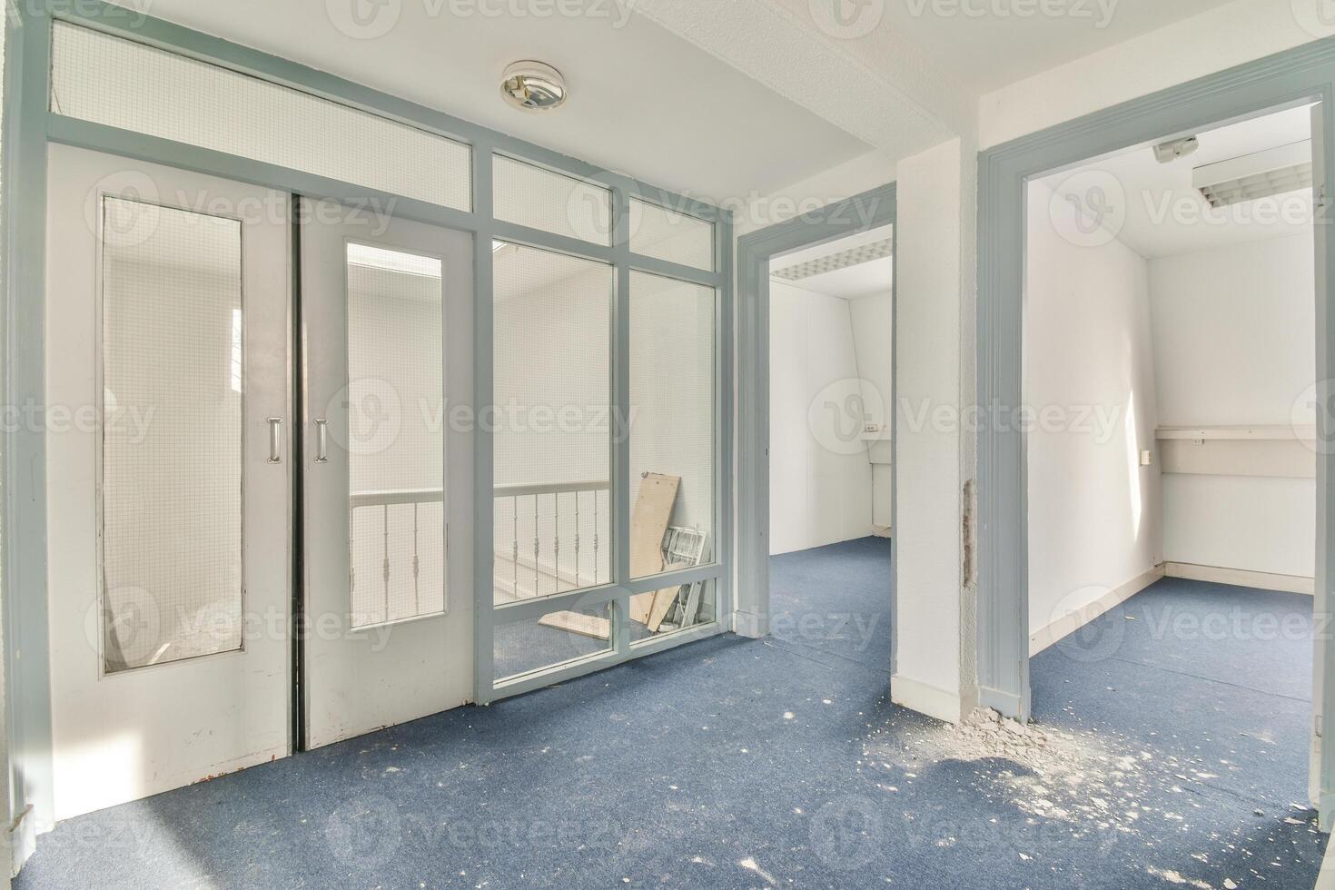 An empty room with blue carpet and white walls photo