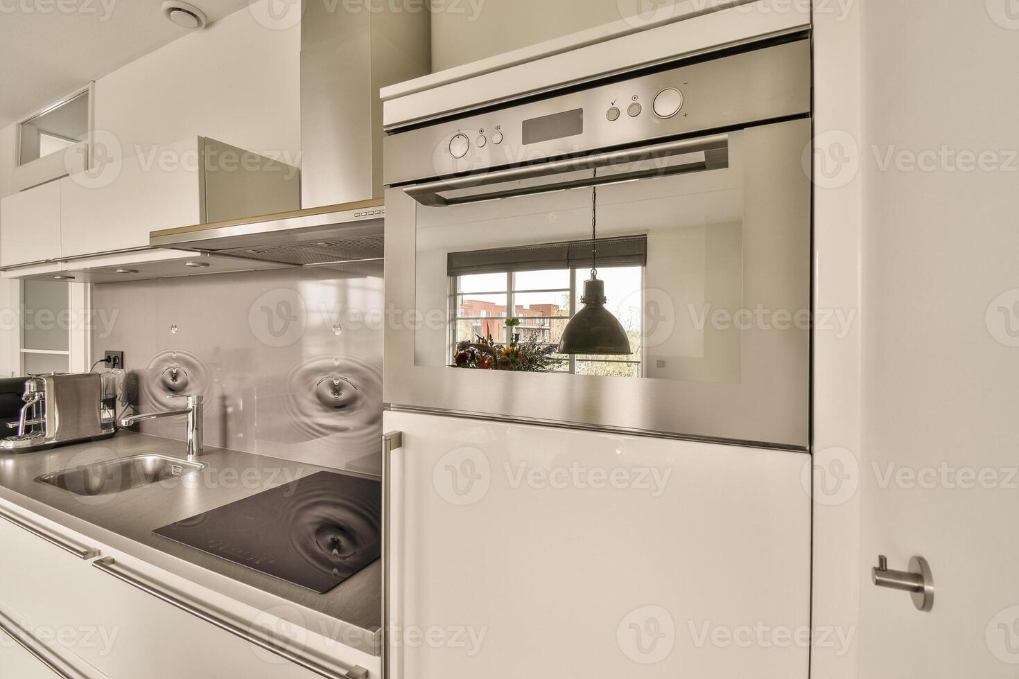 A kitchen with a stove and oven photo