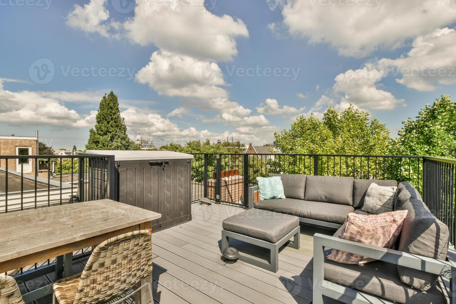 A deck with a patio furniture set and a hot tub photo