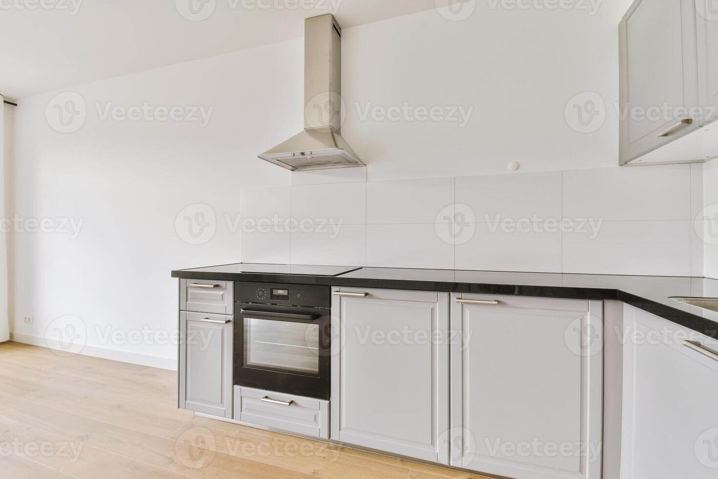 An empty kitchen with a stove and oven photo