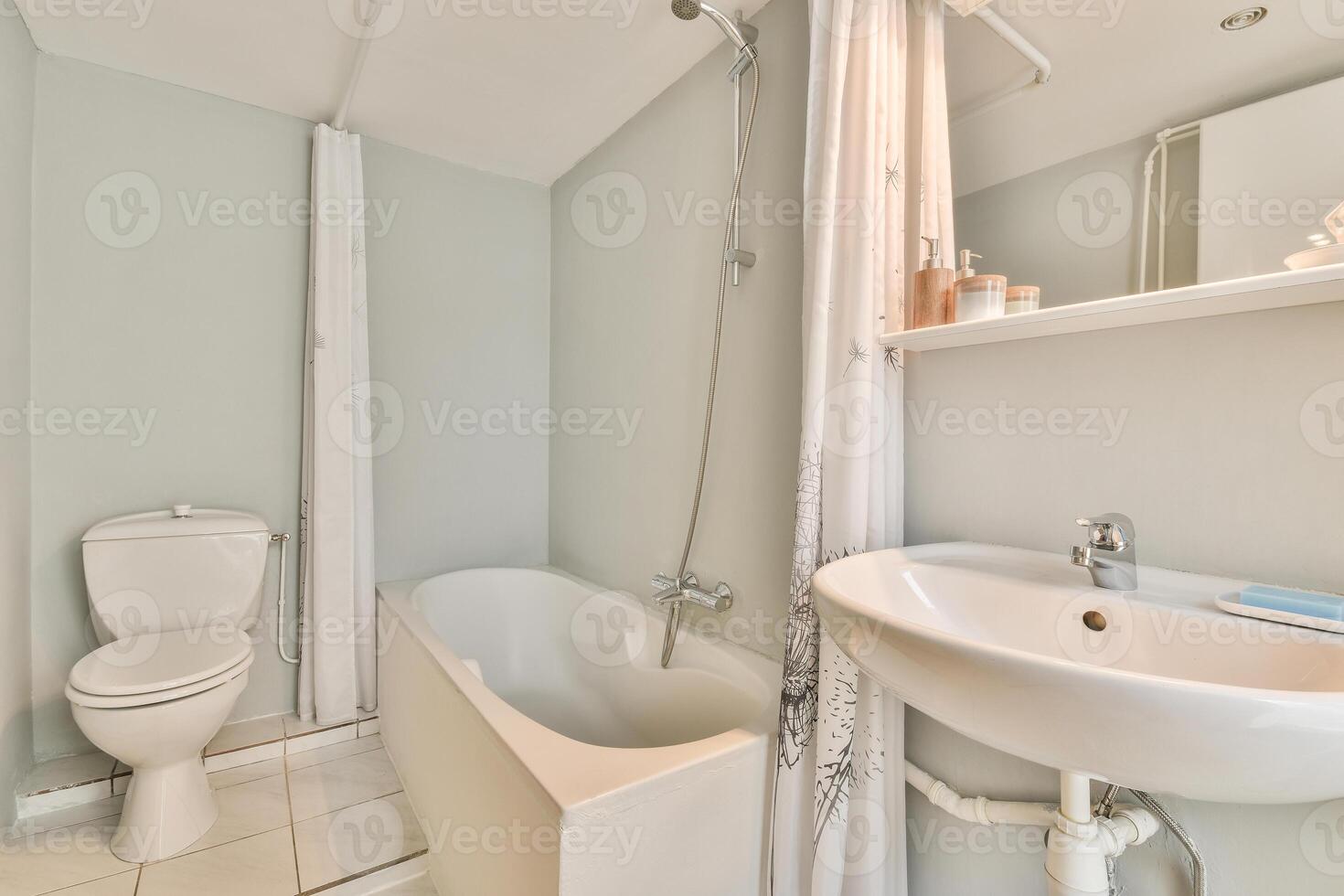 A bathroom with a toilet, sink and bathtub photo