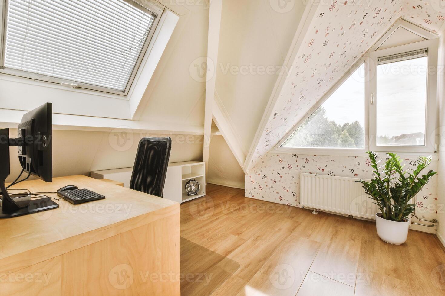 A home office with a desk and computer photo