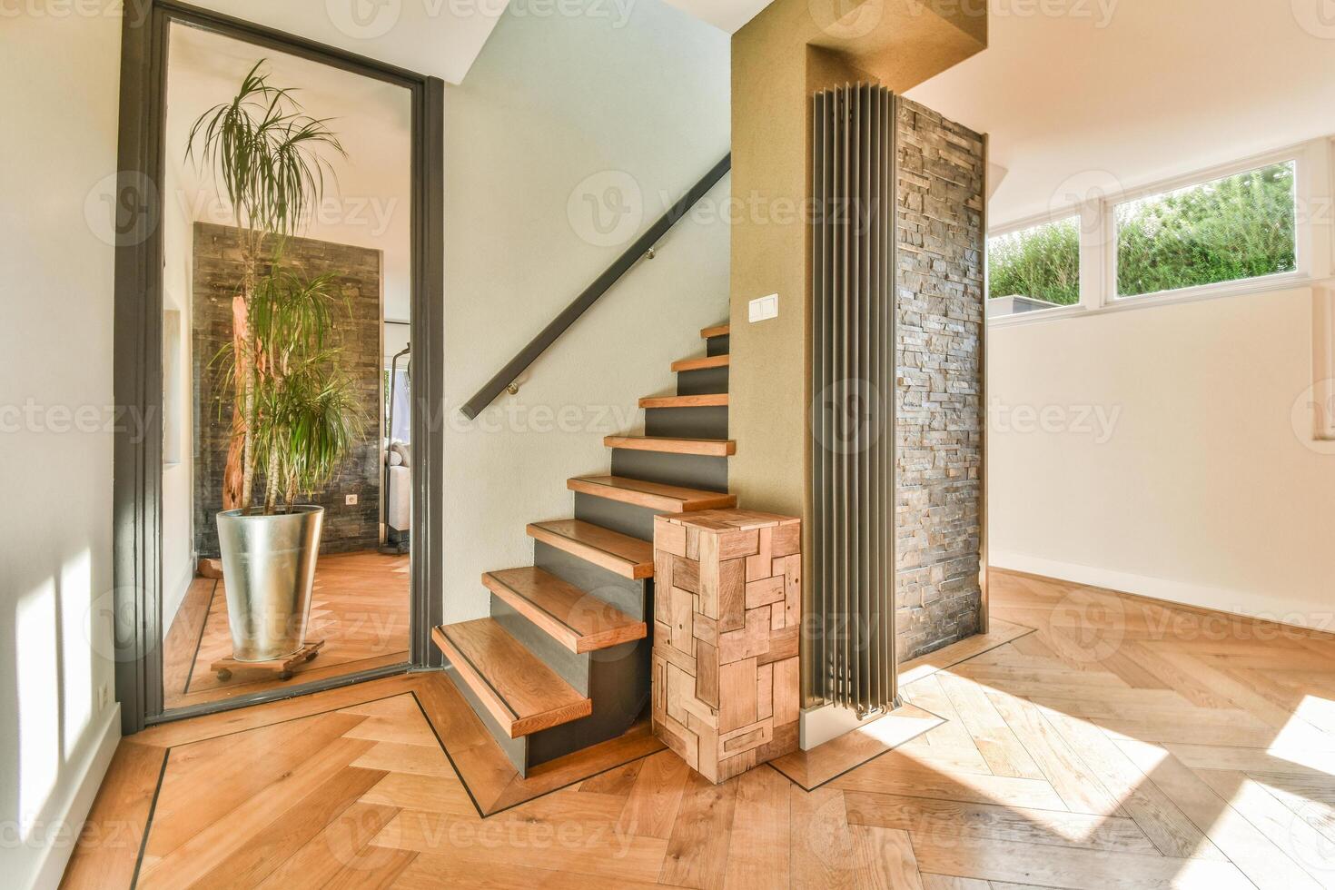 A hallway with wooden floors and a stairway photo