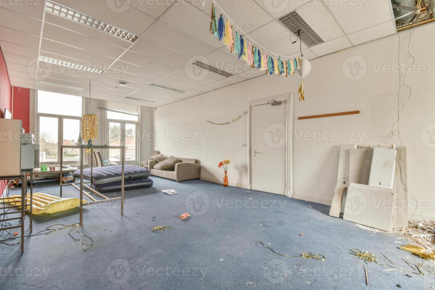 A room with a bed, a couch, a table, and a chair photo