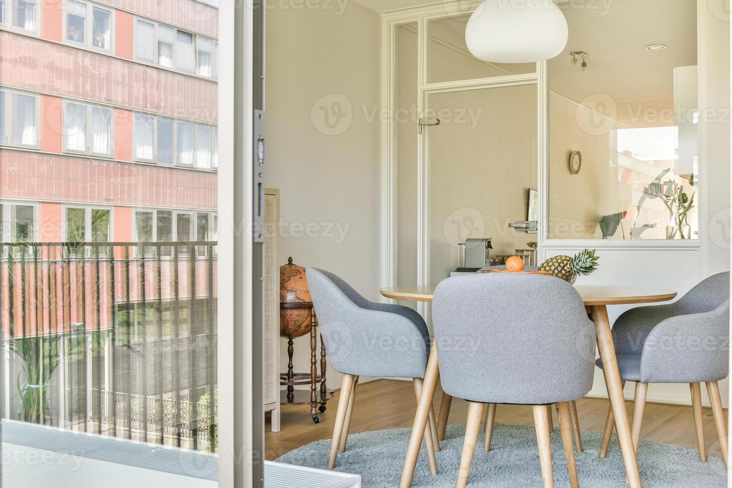 A view of a dining room and kitchen area from an open door photo