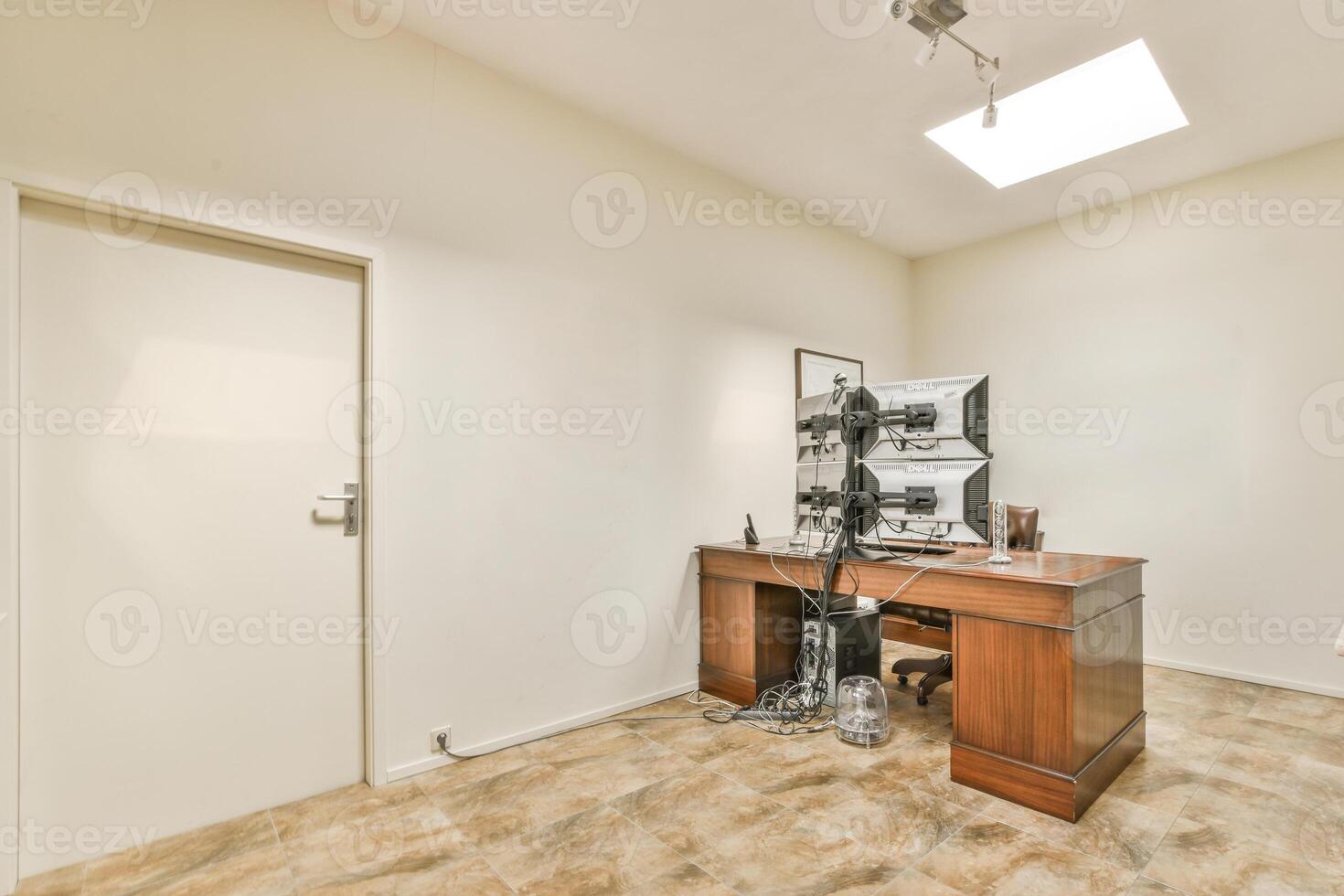 A room with a desk and a chair in it photo
