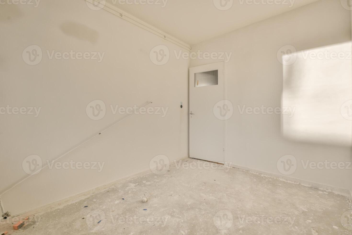 An empty room with a door and a window photo