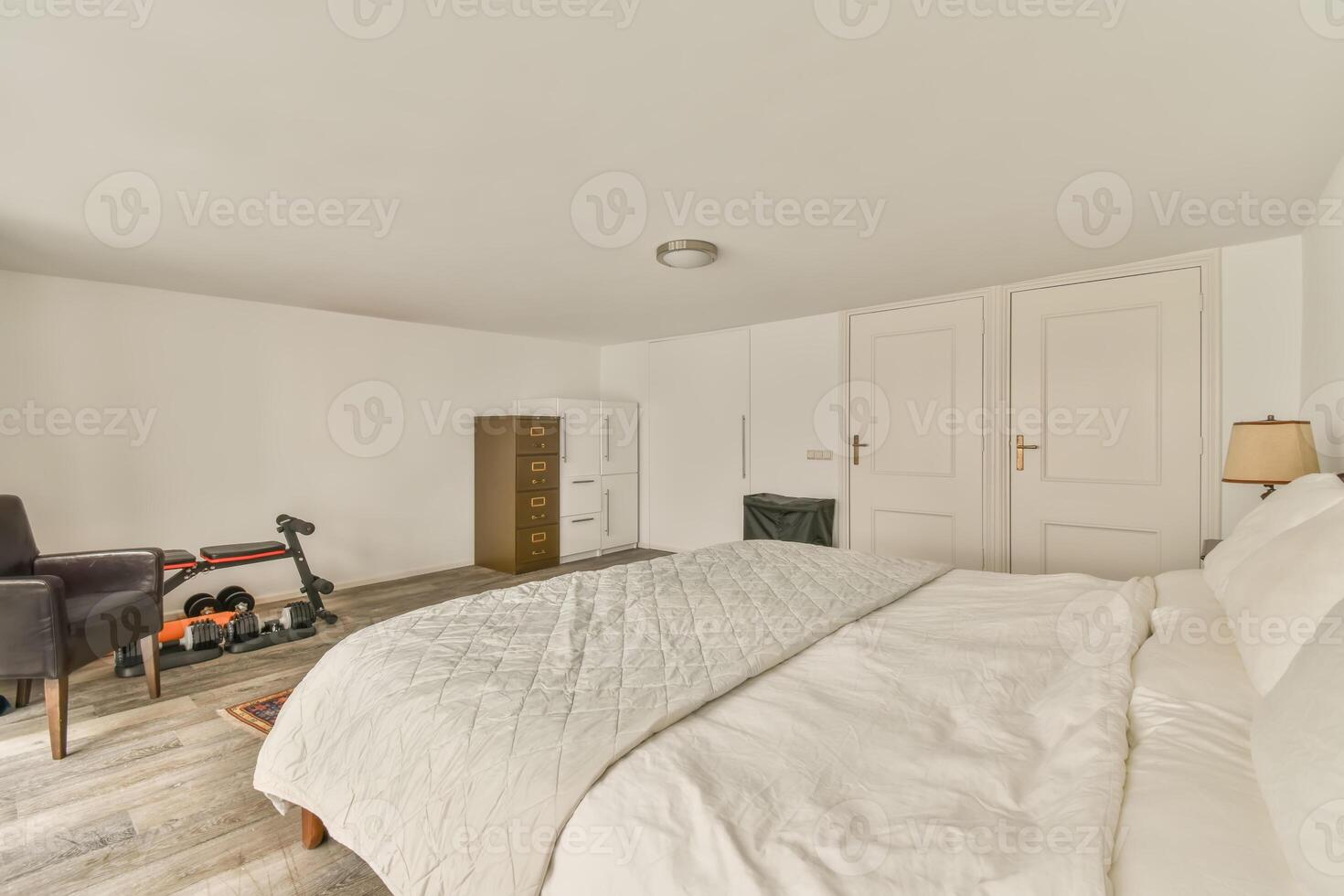 A bedroom with a bed, a chair and a television photo