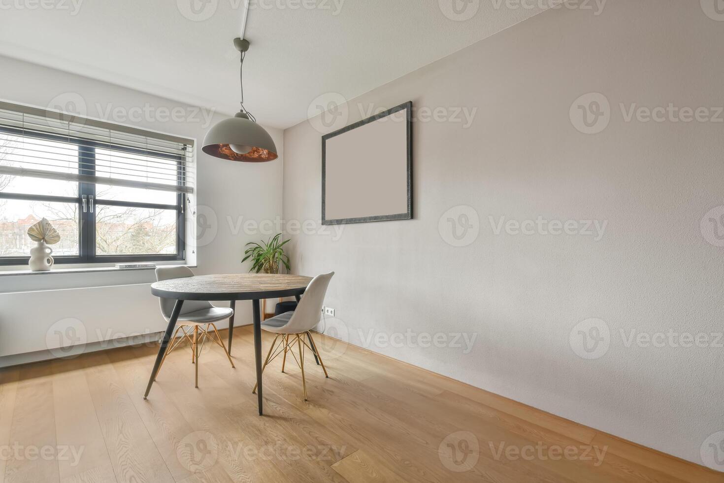 A small dining room with a table and chairs photo
