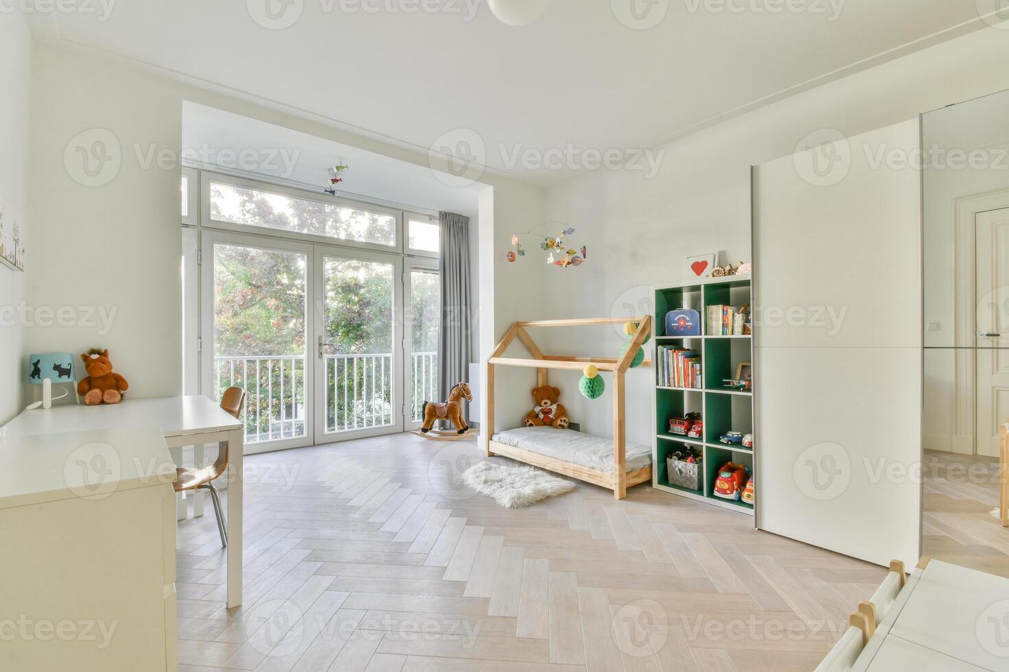 A white room with a wooden floor and a wooden bed photo