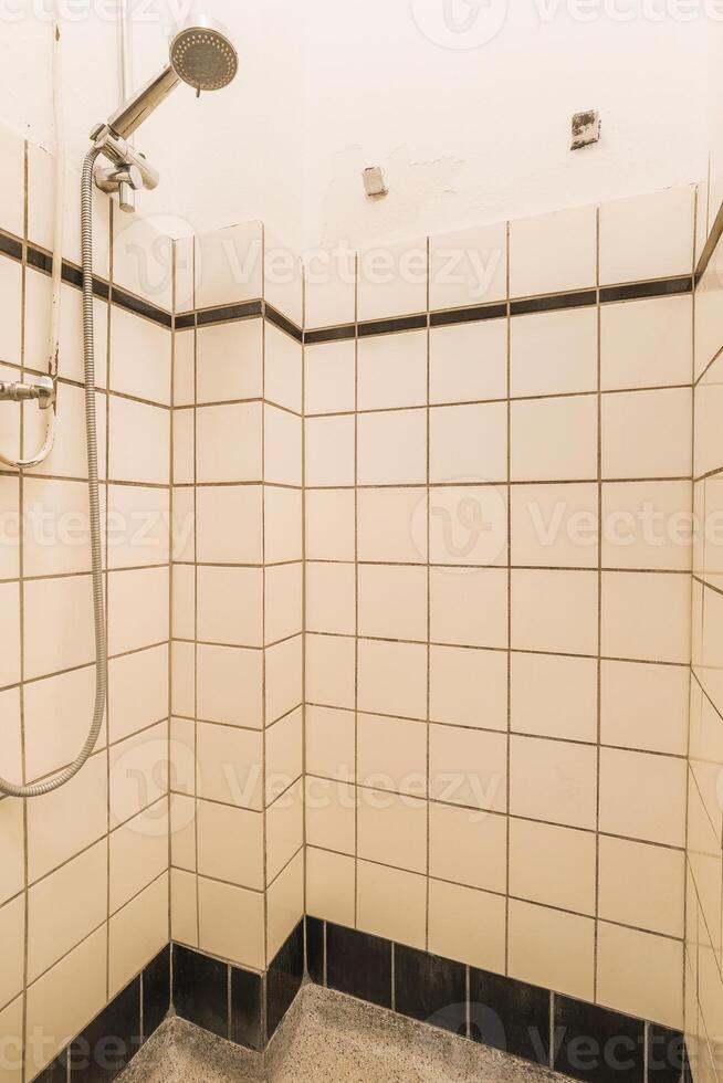 A shower with a shower head photo