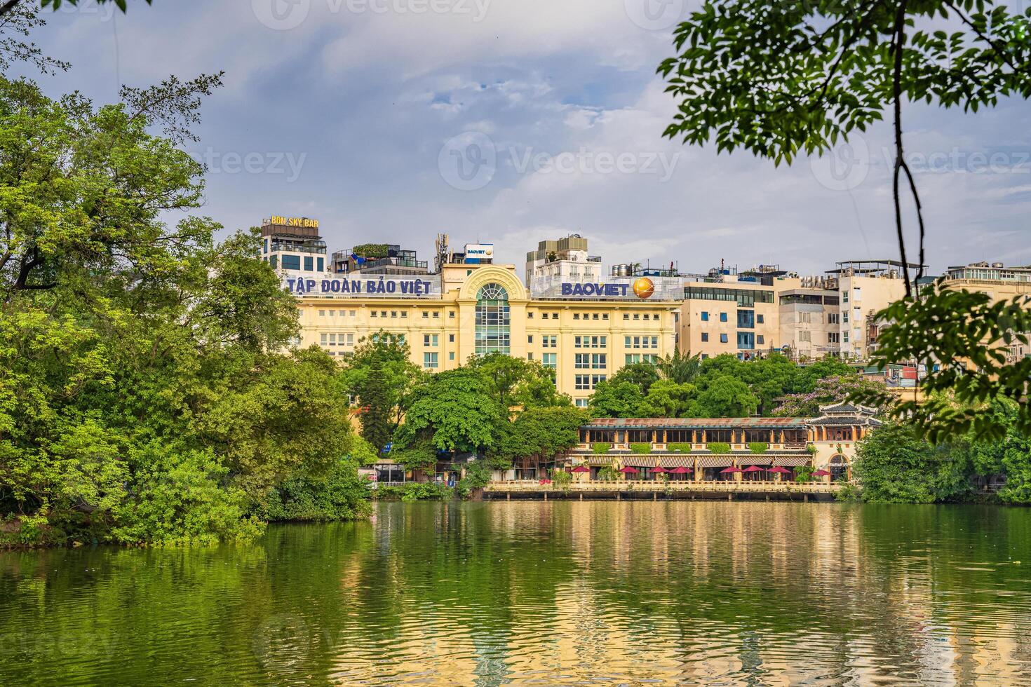 Hanoi, Vietnam - 26 June 2024 Hoan Kiem lake or Sword lake, Ho Guom in Hanoi, Vietnam with Turtle Tower, on clear day with blue sky and white clouds photo