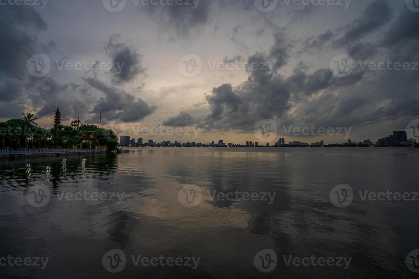 Hanoi, Vietnam - 25 Jun 2024 West Lake in Hanoi in the dark cloudy evening. Ha Noi cityscape. Travel concept photo