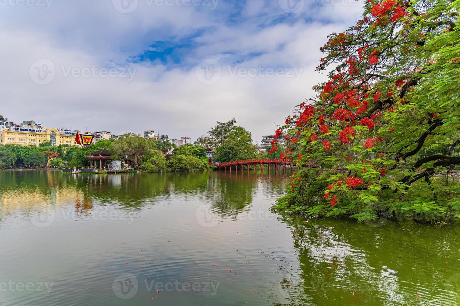 Hanoi, Vietnam - 26 June 2024 Red The Huc Bridge and Ngoc Son Temple in the center of Hoan Kiem Lake, Hanoi, Vietnam. Famous destination of Vietnam photo