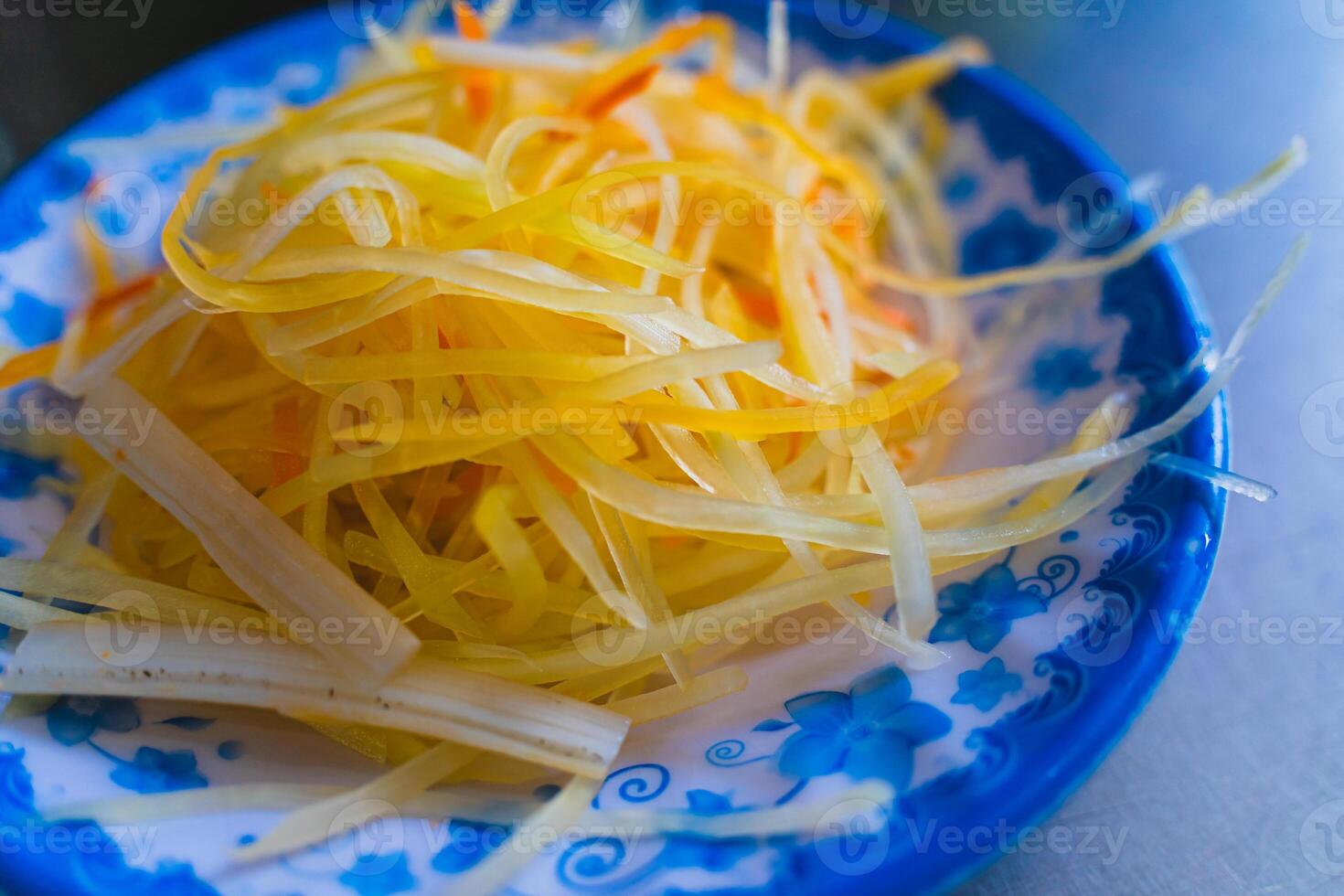 Shredded papaya served with Vung Tau pancakes. A famous dish in Vietnam. photo