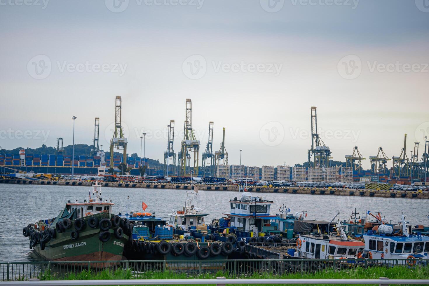 Tuas Second Link Bridge connecting Singapore and Johor, Malaysia. Buildings at Forest City and Singapore's port. View from the Straits of Johor. photo