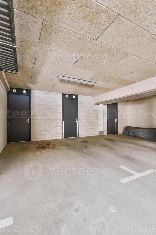 An empty parking garage with two doors photo