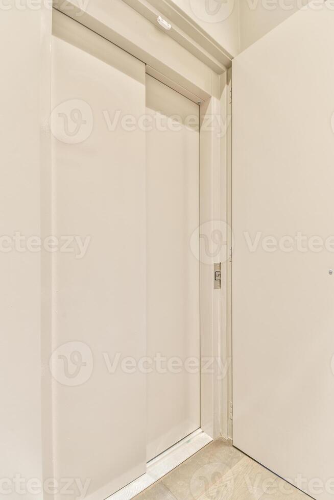 A white door with a sliding door and a white wall photo