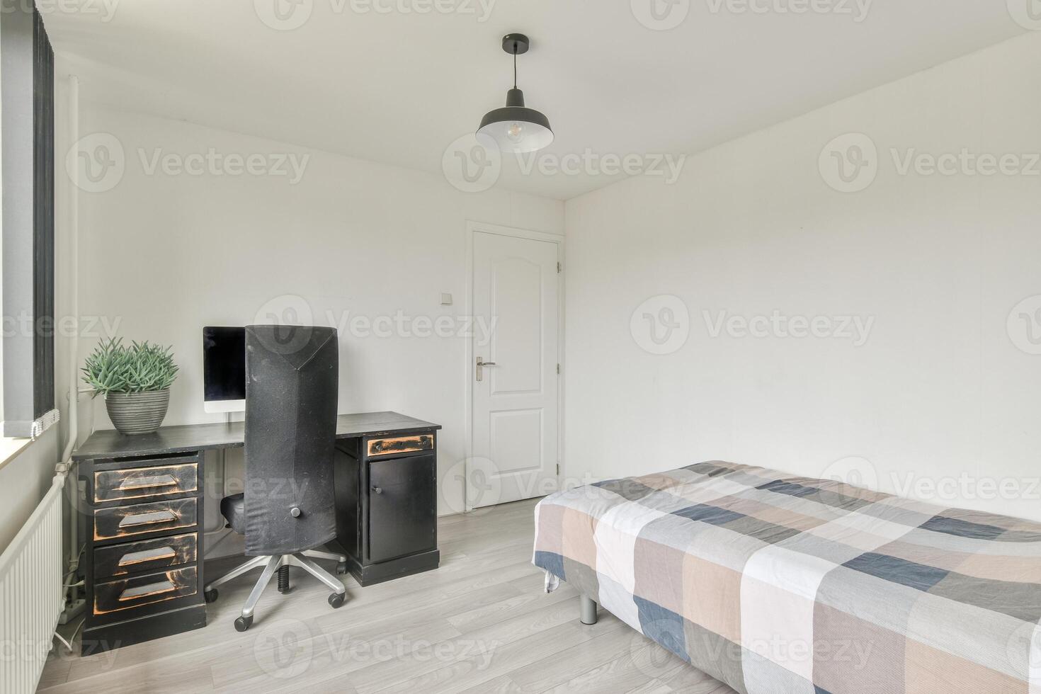 A bedroom with a desk, chair and bed photo