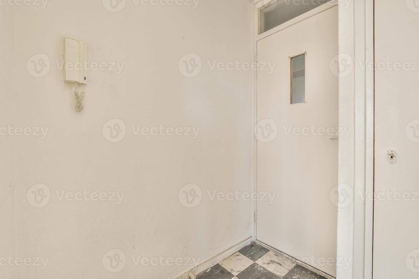 A white door and a black and white checkered floor photo