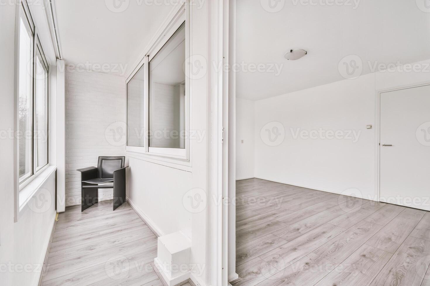 An empty room with a chair and a window photo