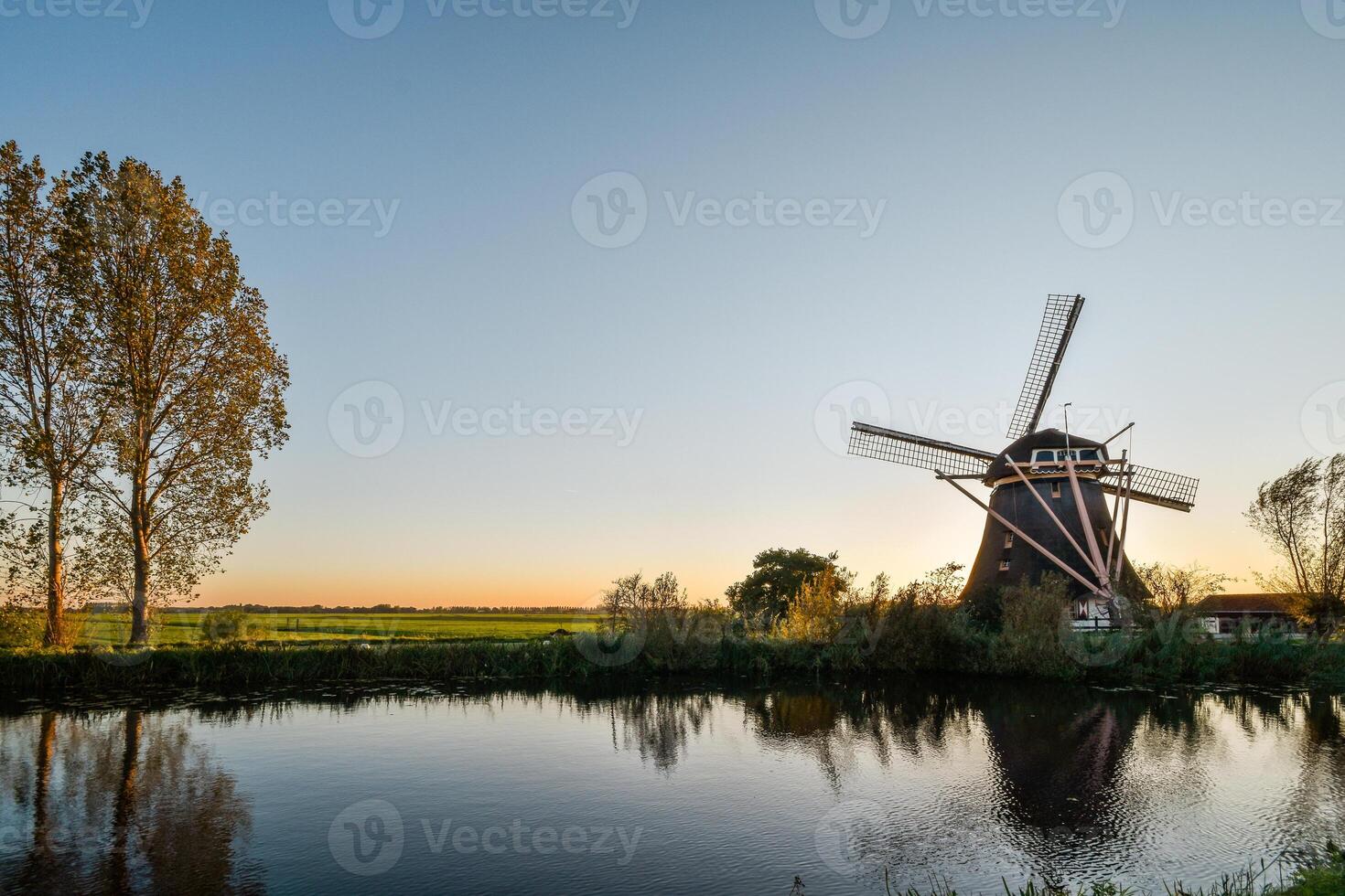 A windmill in the middle of a field photo