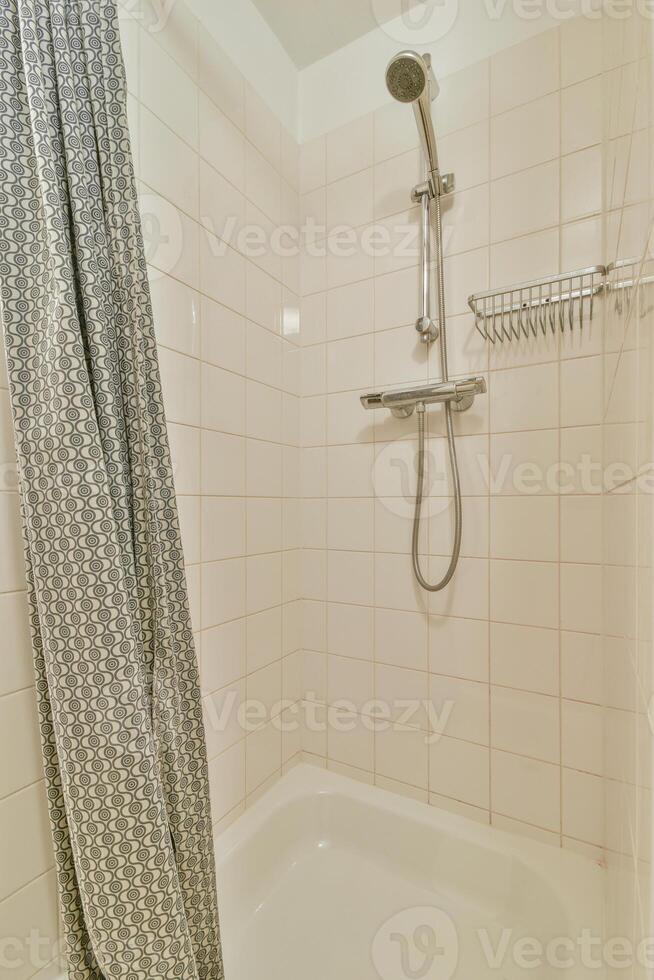 A shower with a shower head photo