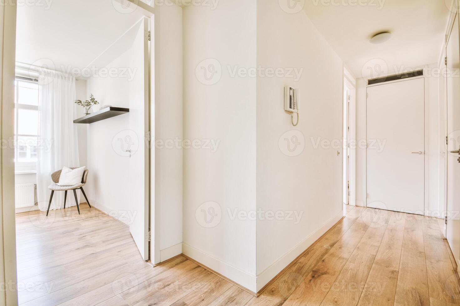 A hallway with wooden floors and white walls photo