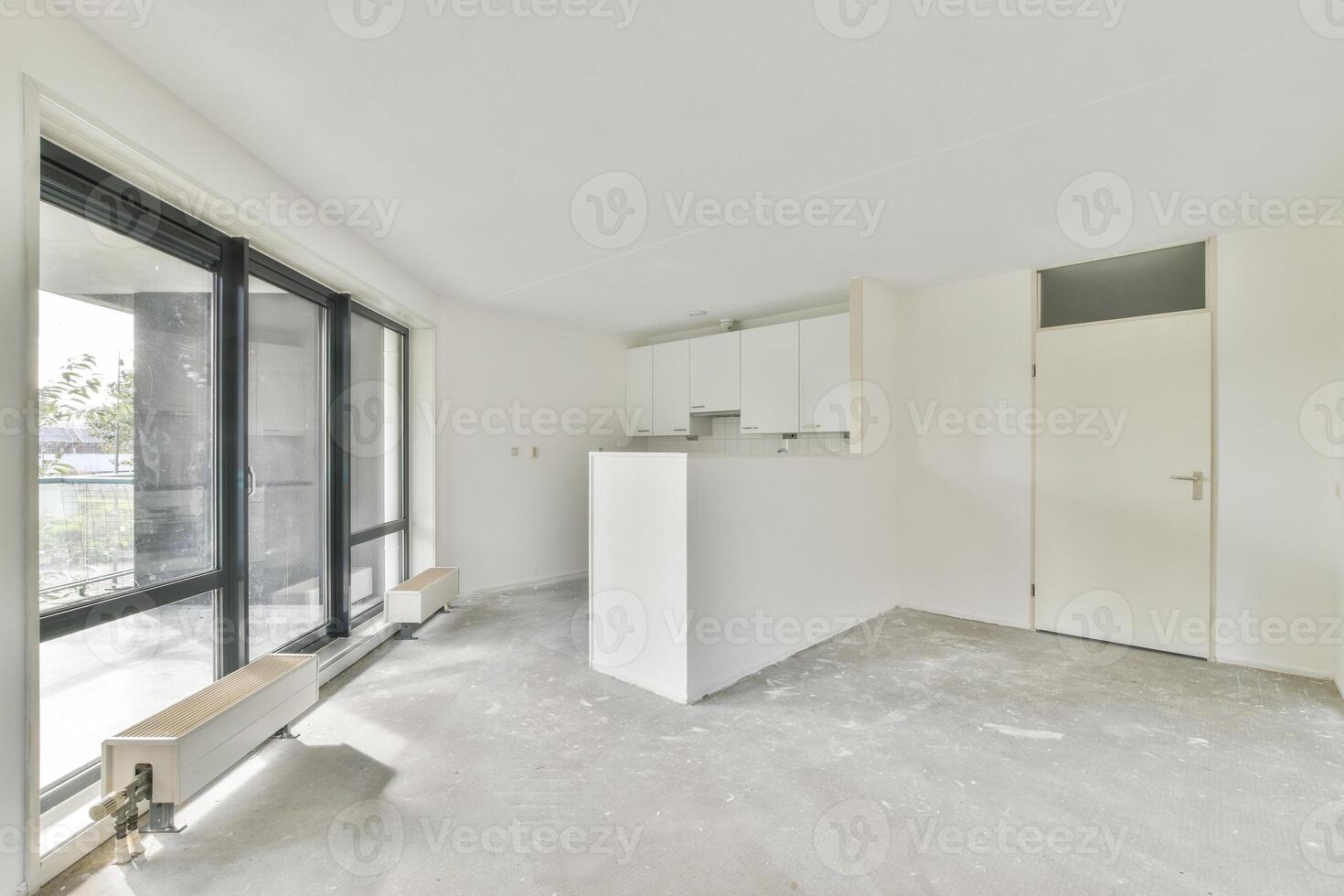 An empty room with a large window and a white wall photo