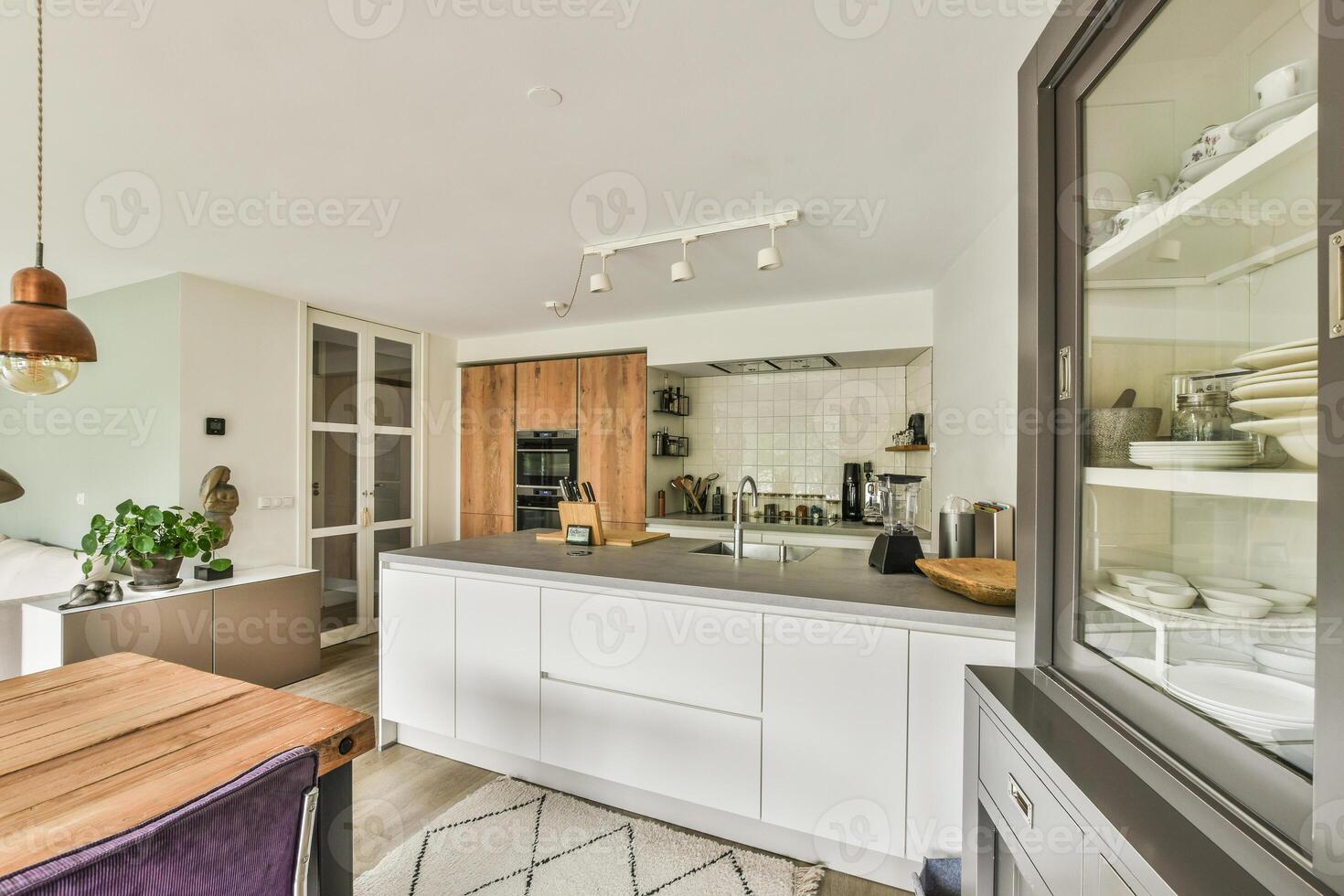 A kitchen with a dining table and chairs photo