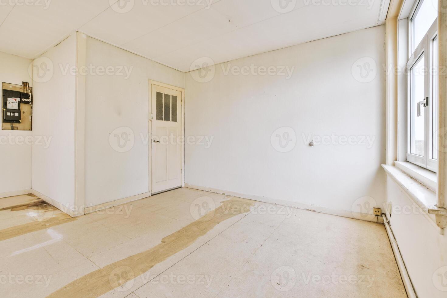 An empty room with a window and a door photo