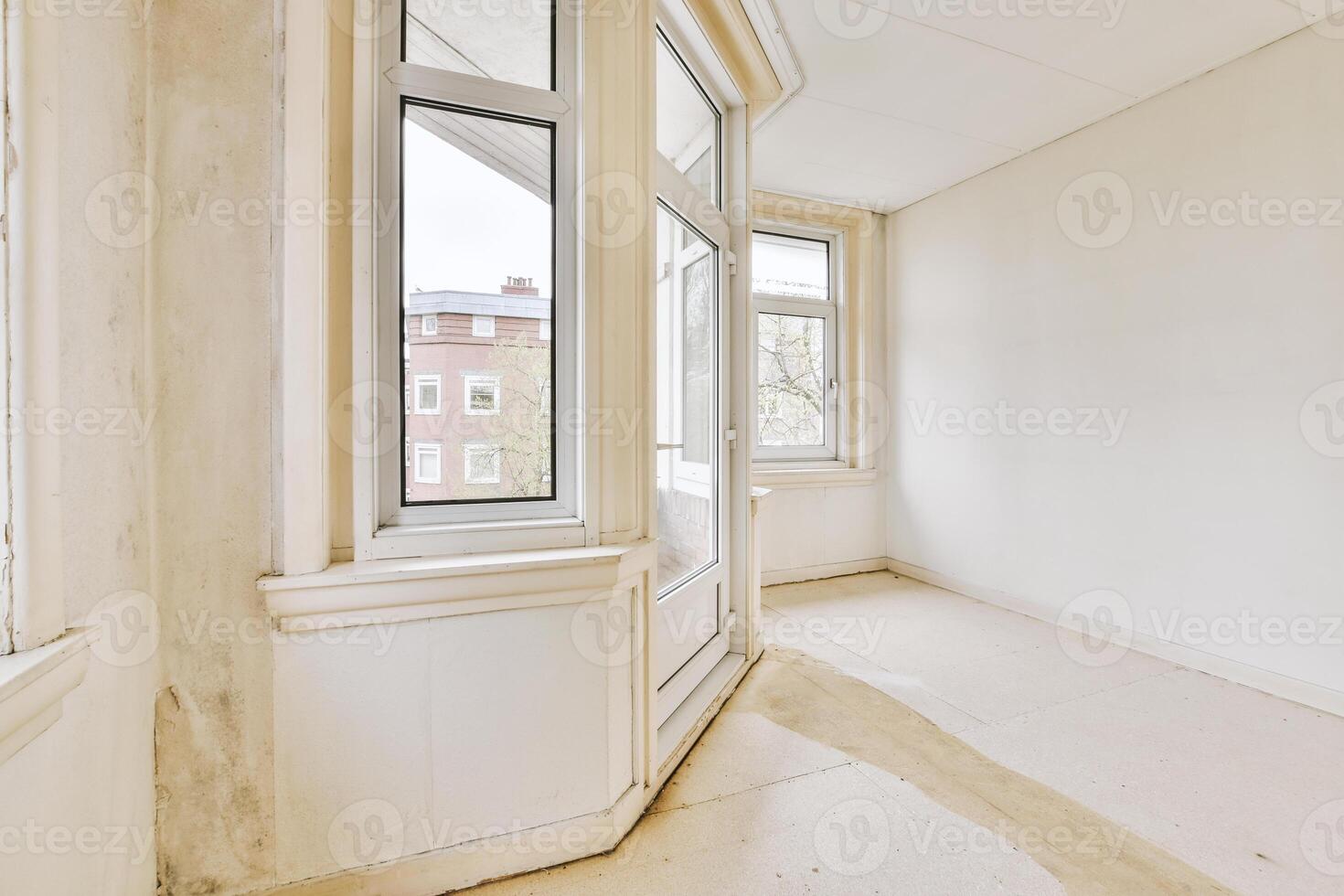 An empty room with a window and a door photo