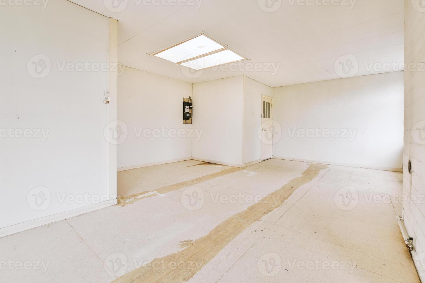 A room with a skylight and a door photo