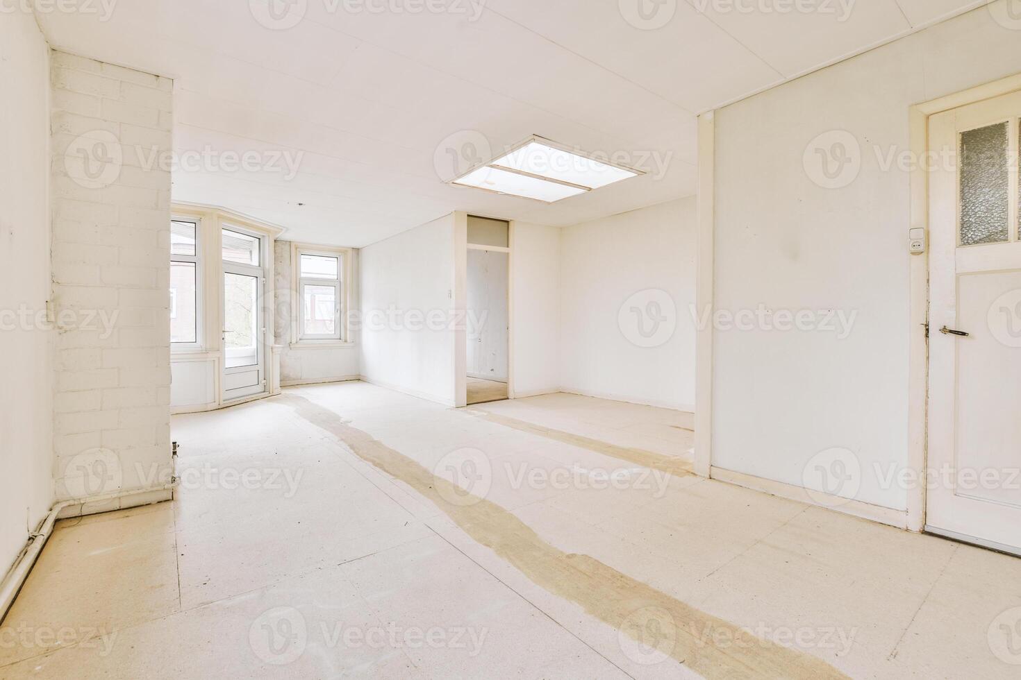 A room with a white door and a window photo